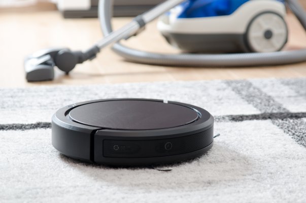 robot vacuum cleaners black vacuum on the carpet traditional vacuum cleaner